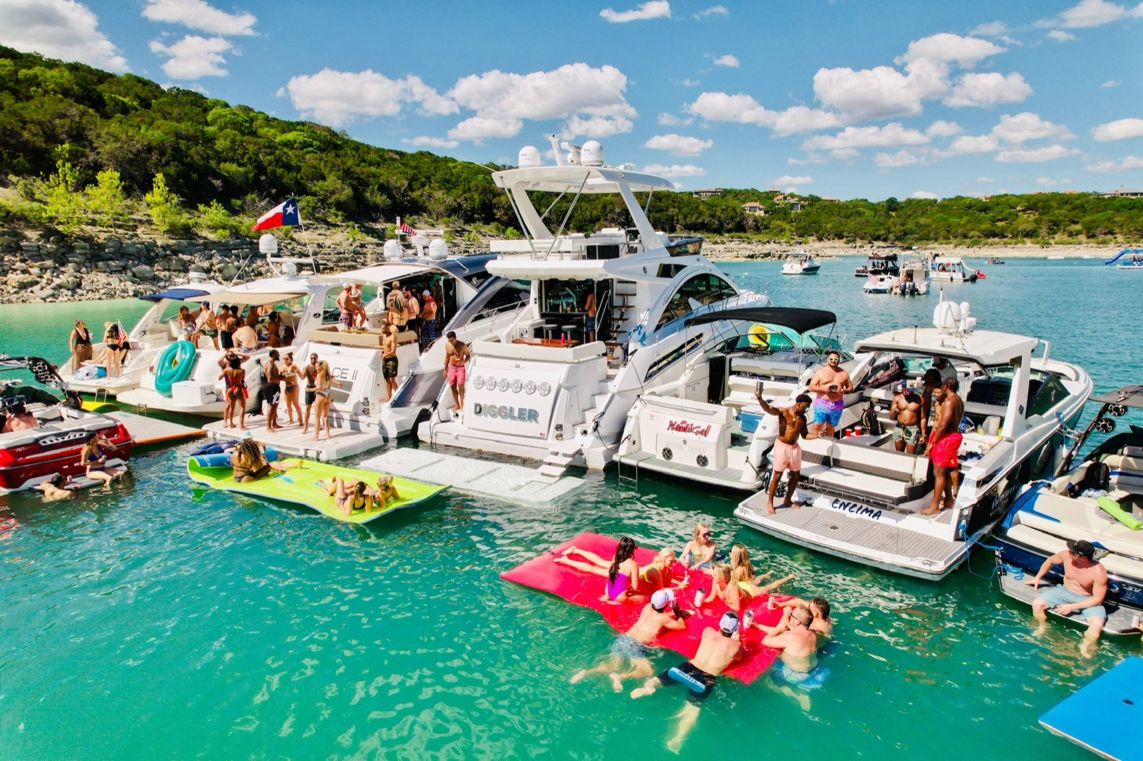 Bachelorette party crews on floats and boats rafted up at Devils Cove on Lake Travis